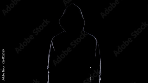 Dangerous anonymous male in night darkness, scary terrorist preparing for crime