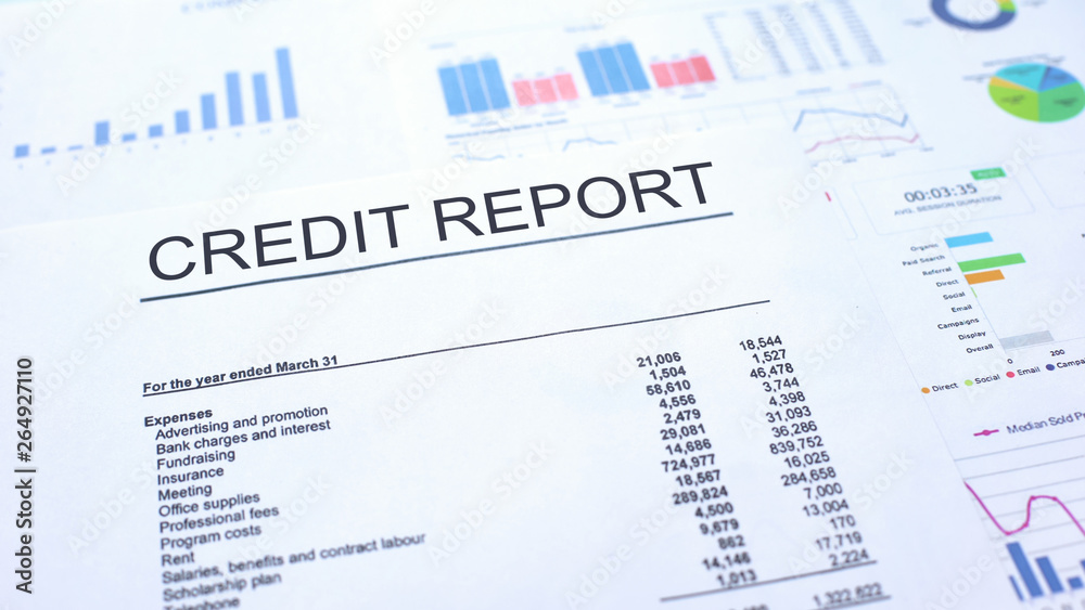 Credit report lying on table, graphs charts and diagrams, official document Credit report lying on table, graphs charts and diagrams, official document
