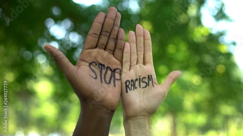 Interracial people hands with stop racism phrase, fight against discrimination