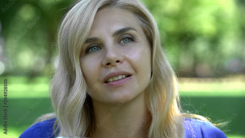 Fototapeta premium Beautiful woman dreaming in park, perfect skin close up, cosmetologist procedure