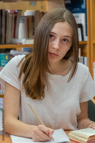Student doing her homework in the school library