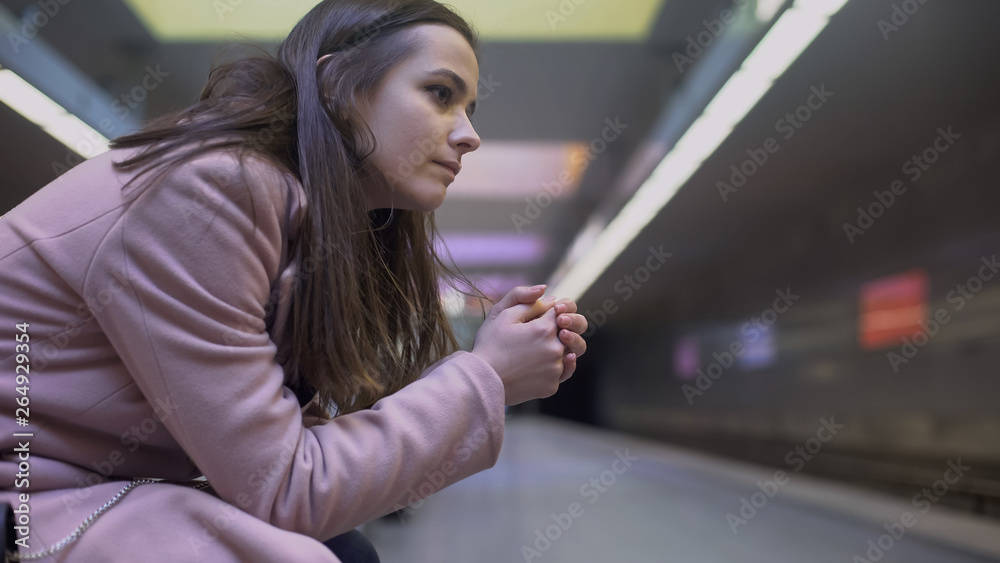 Nervous young female suffering anxiety attack on subway station, suicide attempt Nervous young female suffering anxiety attack on subway station, suicide attempt