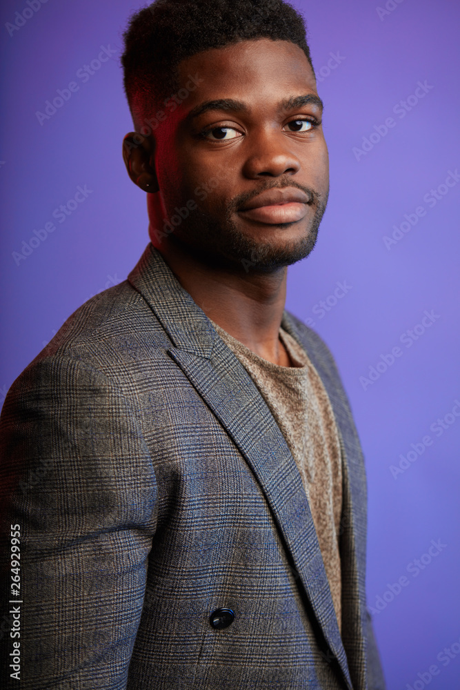 Handsome unshaven young dark-skinned male laughing out loud at funny meme he found on internet, smiling broadly, showing his white straight teeth. Positive human facial expressions and emotions