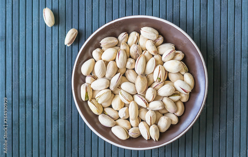 Healthy food for background image close up pistachios nuts. Texture on top view Nuts pistachio on the cup plate Healthy food for background image close up pistachios nuts. Texture on top view Nuts pistachio on the cup plate