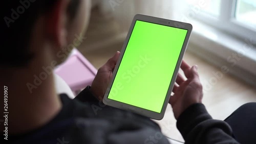 boy watching tablet vertically