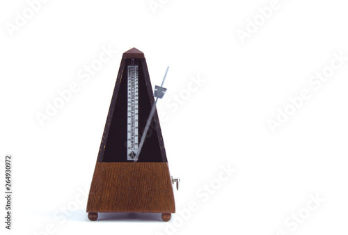 old classic metronome in motion in brown wood photo