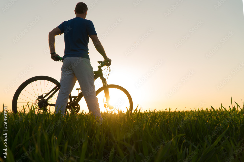 Fototapeta premium man on bike. sunset bike. bike at sunset.