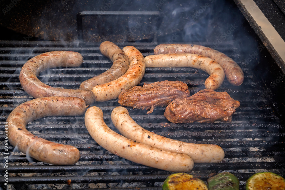 Fototapeta premium Sausages and meat steak are grilled over charcoal. Street food