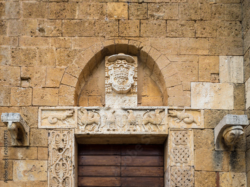 The carved stone entrance of an ancient Italian medieval church.