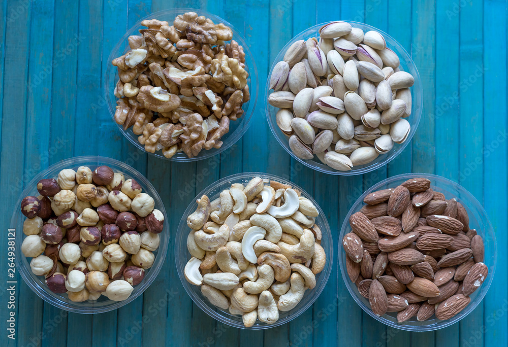 Healthy food. Nuts mix assortment on stone texture top view. Collection of different legumes for background image close up nuts, pistachios, almond, cashew nuts, peanut, walnut. image Healthy food. Nuts mix assortment on stone texture top view. Collection of different legumes for background image close up nuts, pistachios, almond, cashew nuts, peanut, walnut. image