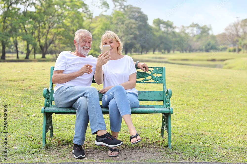 elderly couple laughing while using video call from smart phone to grandchild elderly couple laughing while using video call from smart phone to grandchild