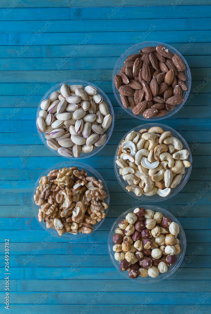Healthy food. Nuts mix assortment on stone texture top view. Collection of different legumes for background image close up nuts, pistachios, almond, cashew nuts, peanut, walnut. image Healthy food. Nuts mix assortment on stone texture top view. Collection of different legumes for background image close up nuts, pistachios, almond, cashew nuts, peanut, walnut. image