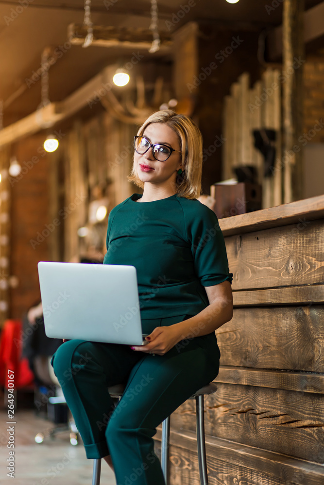 Portrait of pretty young business woman in glasses sitting on workplace Portrait of pretty young business woman in glasses sitting on workplace