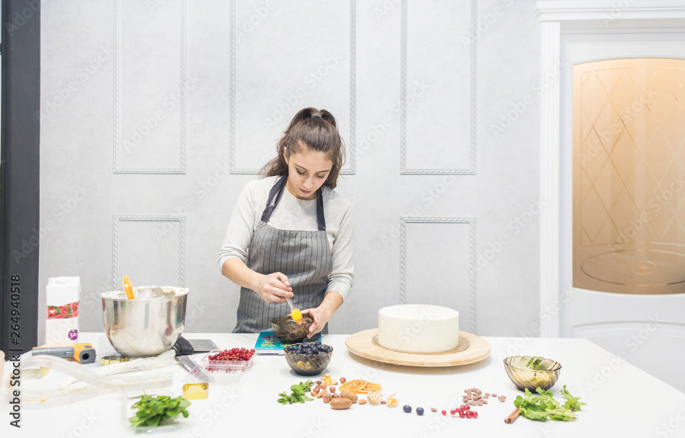 Confectioner prepares a chocolate biscuit cake decorating cream. The concept of homemade pastry, cooking cakes. Confectioner prepares a chocolate biscuit cake decorating cream. The concept of homemade pastry, cooking cakes.
