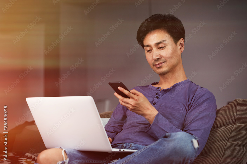 Asian Man Working Laptop Home Connecting Networking Concept.