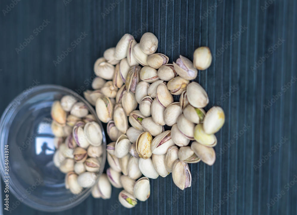 Healthy food  for background image close up pistachios nuts. Texture on top view Nuts pistachio on the cup plate