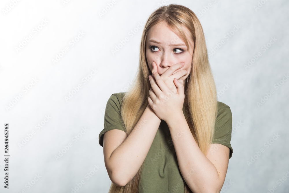 Surprised young woman covers mouth in shock. Surprised young woman covers mouth in shock.