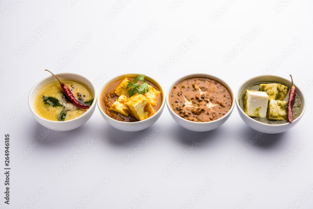 Palak paneer butter masala, yellow dal or dal-makhani served in a bowl in a group. selective focus Palak paneer butter masala, yellow dal or dal-makhani served in a bowl in a group. selective focus