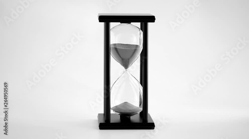 Black and White of Hourglass with sand running through the glass bulbs ; time passing concept