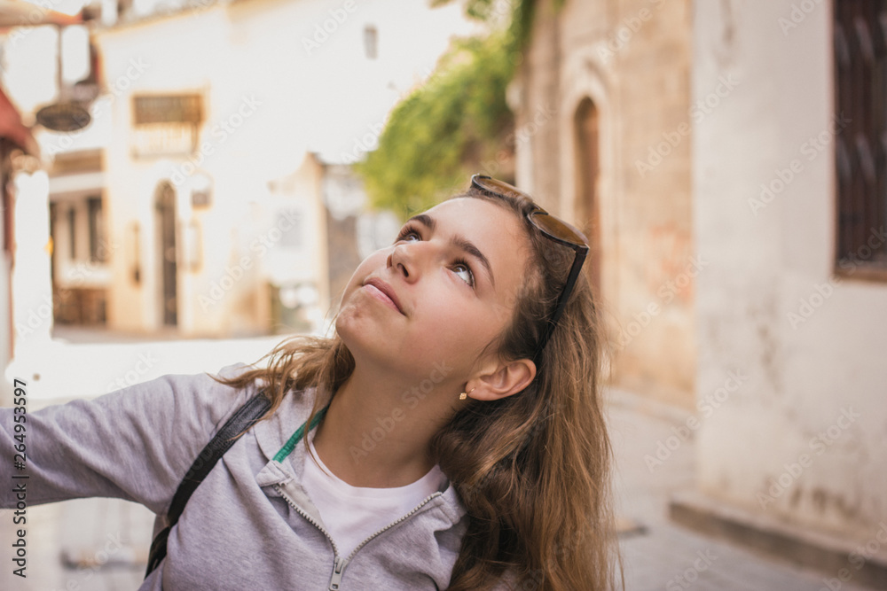 Young beautiful girl walks along the stone street of the old city of Antalya Young beautiful girl walks along the stone street of the old city of Antalya