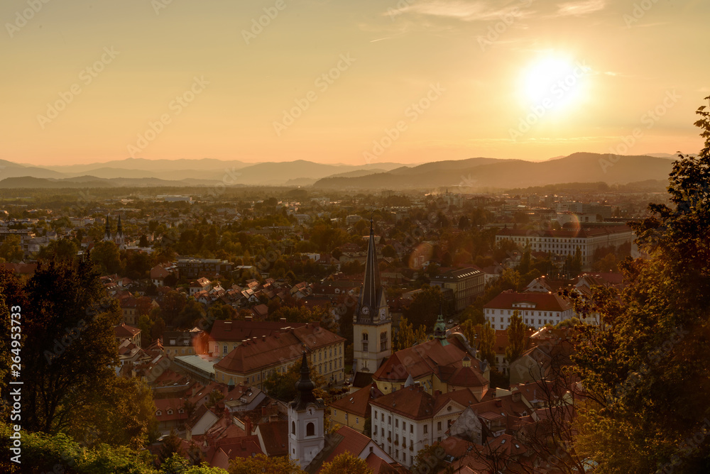 View of Ljubljana city and mountain rnge as background at sunset with dramatic cloudscape, Slovenia