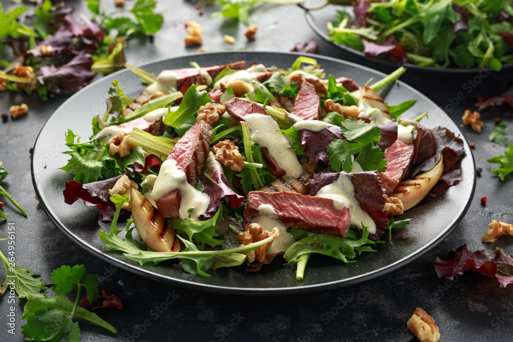 Grilled Beef Steak salad with pears, walnuts and greens vegetables and blue cheese sauce. healthy food. Grilled Beef Steak salad with pears, walnuts and greens vegetables and blue cheese sauce. healthy food.