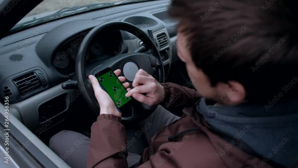 close up - man driver using smartphone with green screen. close up - man driver using smartphone with green screen.