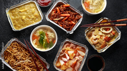 Chinese takeaway food. Pork Wonton dumpling soup, Crispy shredded beef, sweet and sour pineapple chicken, egg noodles with bean sprouts, curry. photo