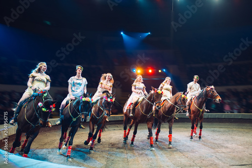 Horses in the circus. Speech horses with trainers on the stage of the circus.