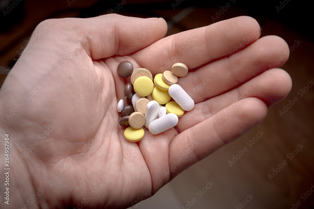 hand with pills hand with pills