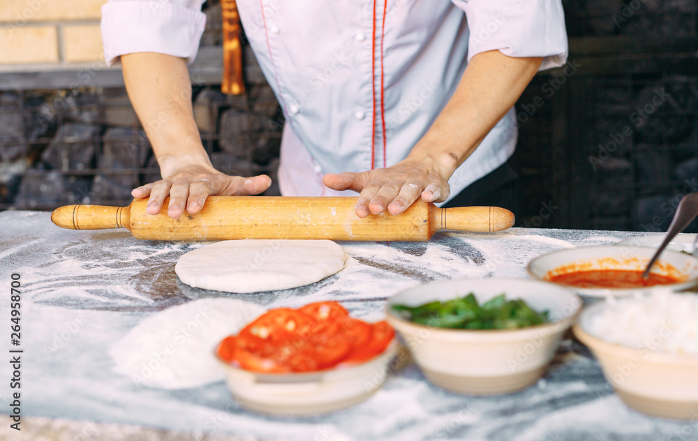 Cooking Pizza. Pizza ingredients on the  table.