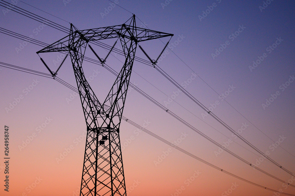 high voltage pylon at sunset