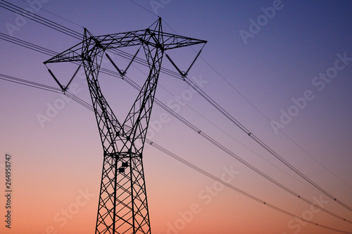 high voltage pylon at sunset