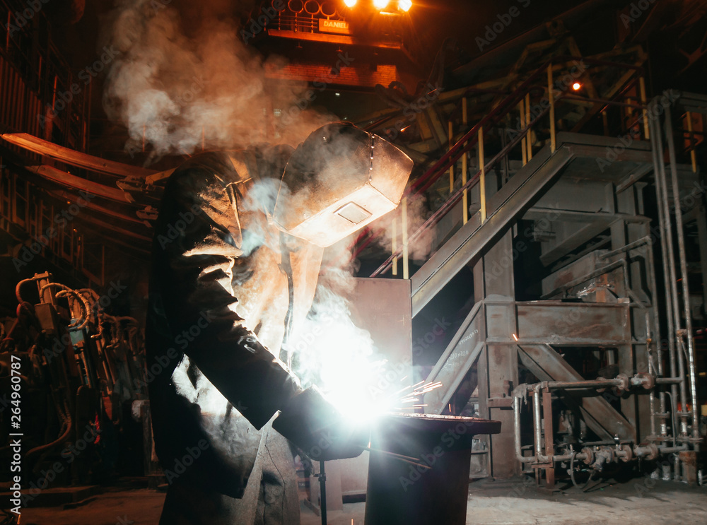 Industrial Worker at the factory welding closeup Industrial Worker at the factory welding closeup