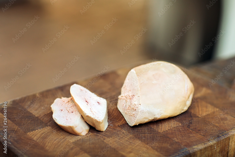 Goose liver on a wooden Board in the restaurant before cooking. Goose liver on a wooden Board in the restaurant before cooking.