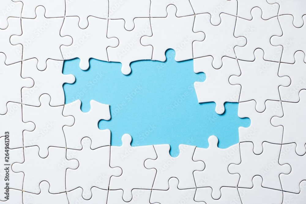 White jigsaw puzzle game pieces on blue background form a banner for business theme design