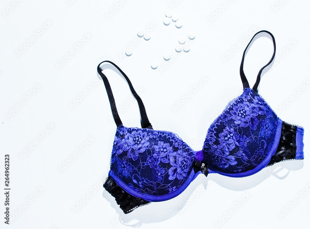 Birth control pills, sexy bra on a gray background. Top view Birth control pills, sexy bra on a gray background. Top view