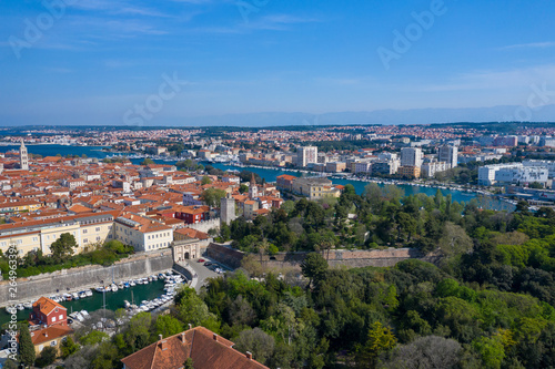 Aerial view of city of Zadar. Summer time in Dalmatia region of Croatia. Coastline and turquoise water and blue sky with clouds. Photo made by drone from above.