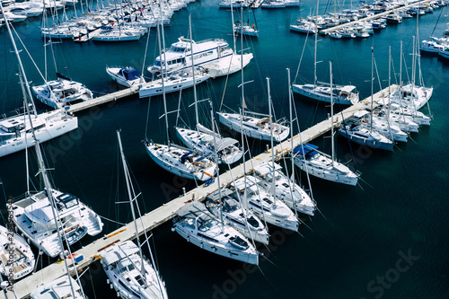 Aerial view of a lot of white boats and yachts moored in marina. Photo made by drone from above. © Curioso.Photography