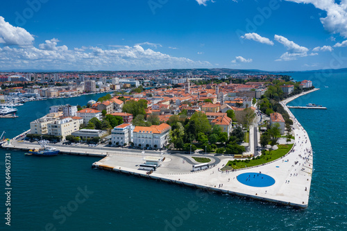 Aerial view of city of Zadar. Summer time in Dalmatia region of Croatia. Coastline and turquoise water and blue sky with clouds. Photo made by drone from above. photo