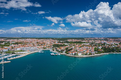 Aerial view of city of Zadar. Summer time in Dalmatia region of Croatia. Coastline and turquoise water and blue sky with clouds. Photo made by drone from above. © Curioso.Photography