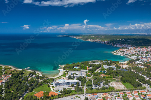 Aerial view of city of Zadar. Summer time in Dalmatia region of Croatia. Coastline and turquoise water and blue sky with clouds. Photo made by drone from above.