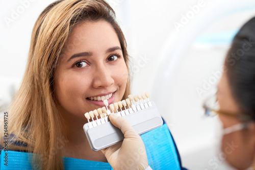 Young woman visiting doctor for teeth whitening
