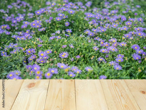 Wood table or terrace with view of flower and nature outdoor.