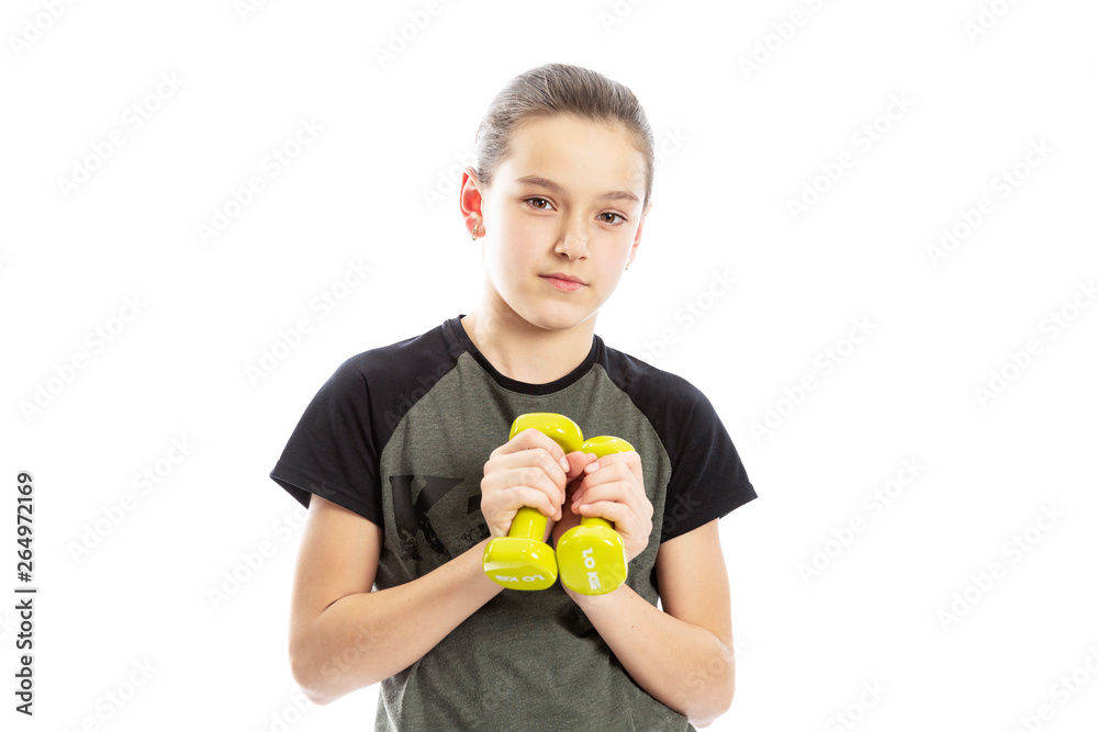 Serious teen girl with dumbbells in their hands. Isolated on a white background. Serious teen girl with dumbbells in their hands. Isolated on a white background.
