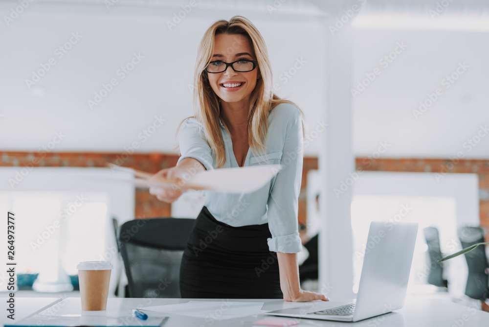 Pretty secretary giving folder with documents and smiling Pretty secretary giving folder with documents and smiling
