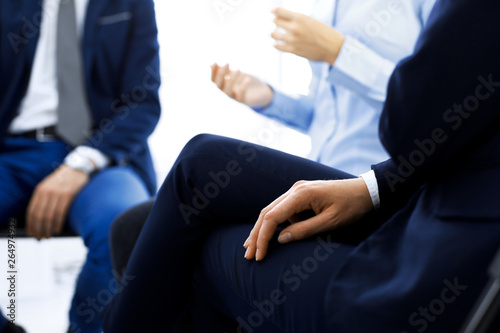 Group of people sitting in a circle during therapy. Meeting of business team participating in training © rogerphoto