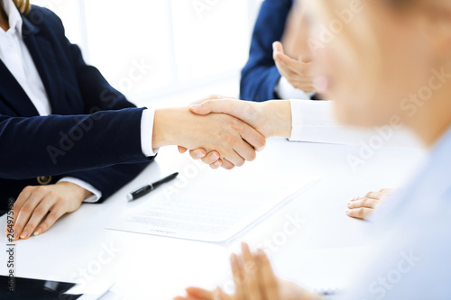 Business people shaking hands finishing up a meeting , close-up. Success at negotiation and handshake concepts. Group of lawyers at work