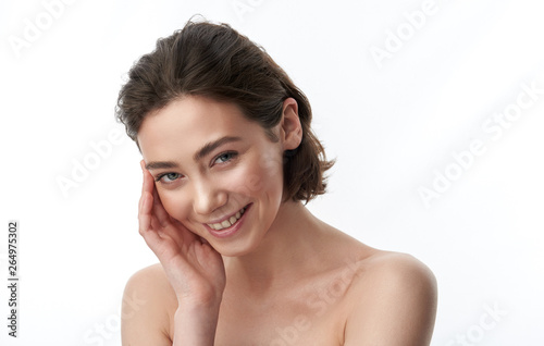 Portrait of pretty brunette female on white