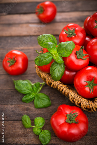 Fresh ripe tomatoes and basil in the basket